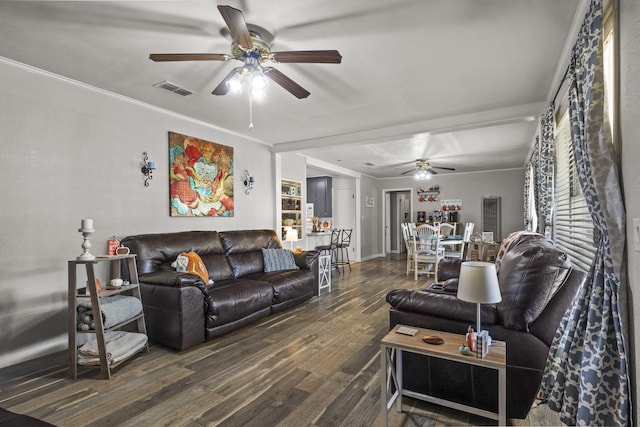 living room with crown molding, visible vents, ceiling fan, and wood finished floors