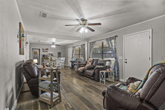 living area featuring a textured wall, wood finished floors, visible vents, and crown molding