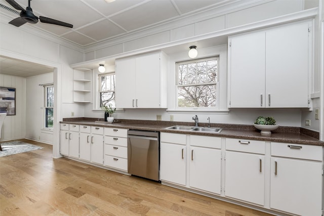 kitchen featuring a sink, dark countertops, light wood finished floors, and dishwasher