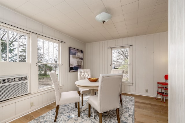 dining space with light wood-type flooring and baseboards