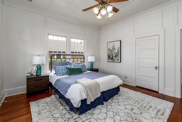 bedroom with baseboards, wood finished floors, and crown molding