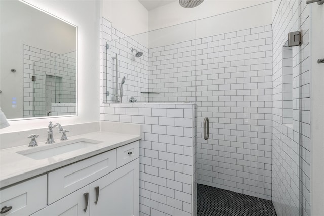 full bathroom with a shower stall and vanity