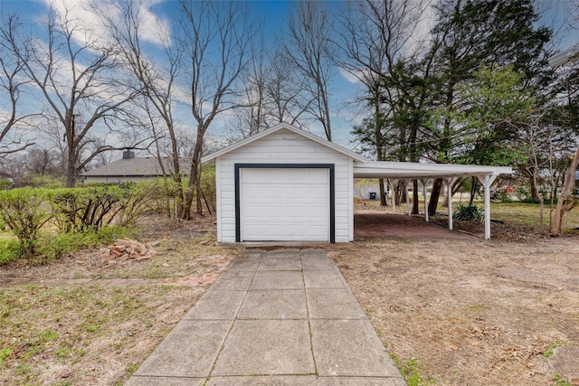 garage featuring concrete driveway and a detached garage