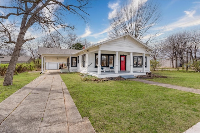 view of front of home with a garage, driveway, a chimney, covered porch, and a front yard