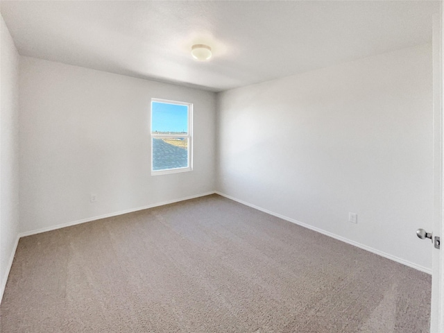 empty room with carpet and baseboards