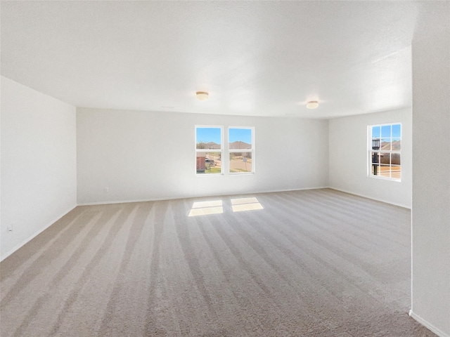 unfurnished room featuring light colored carpet