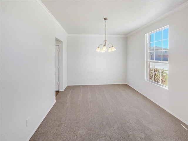 unfurnished room featuring carpet floors, an inviting chandelier, baseboards, and crown molding