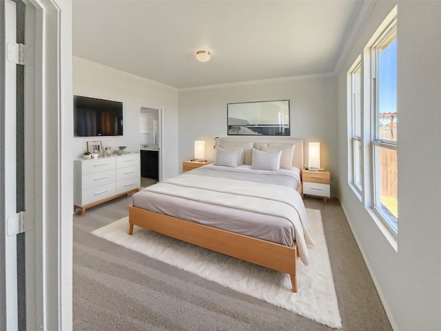 bedroom with multiple windows, crown molding, and light colored carpet