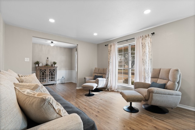 living area featuring recessed lighting, baseboards, and wood finished floors