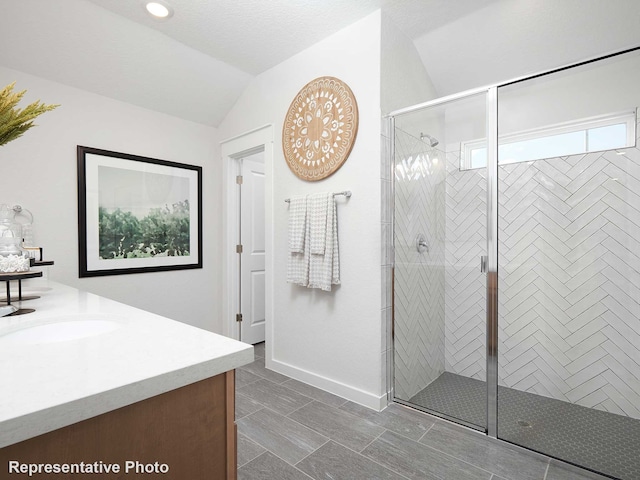 full bath with lofted ceiling, a shower stall, vanity, and baseboards