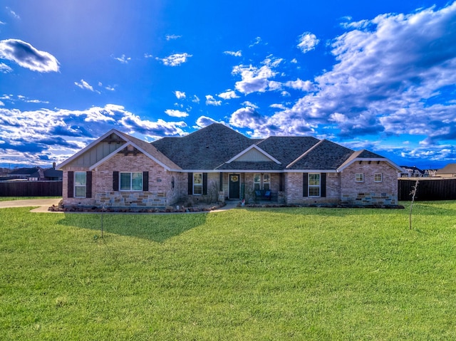 ranch-style house featuring brick siding, a front yard, and fence