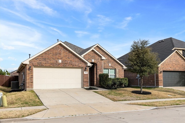 view of front facade with brick siding, central air condition unit, concrete driveway, an attached garage, and fence