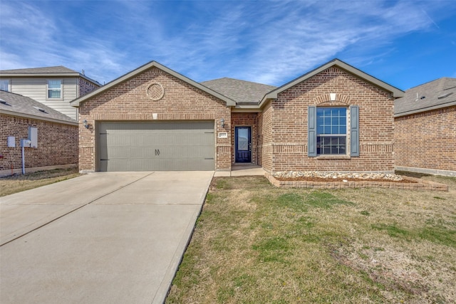 ranch-style home featuring a front yard, concrete driveway, brick siding, and an attached garage