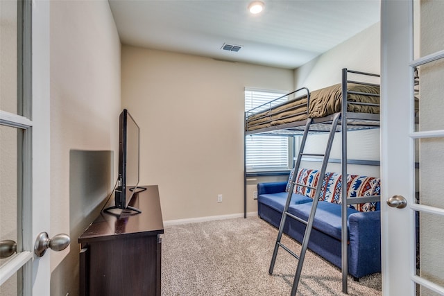 bedroom with carpet floors, french doors, visible vents, and baseboards