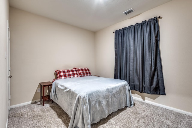 bedroom with carpet flooring, visible vents, and baseboards