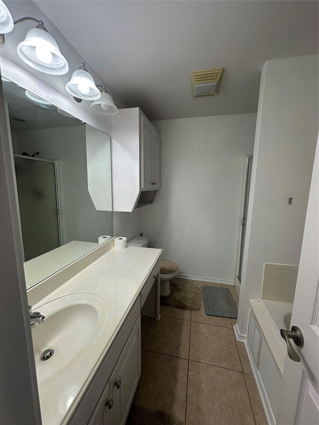 bathroom featuring vanity, visible vents, a stall shower, tile patterned flooring, and toilet