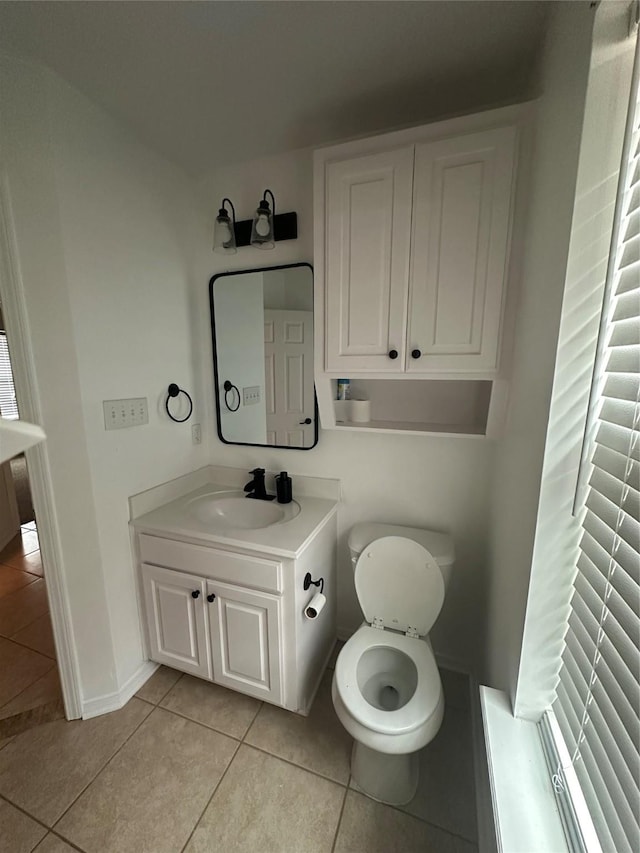 bathroom featuring baseboards, vanity, and tile patterned flooring