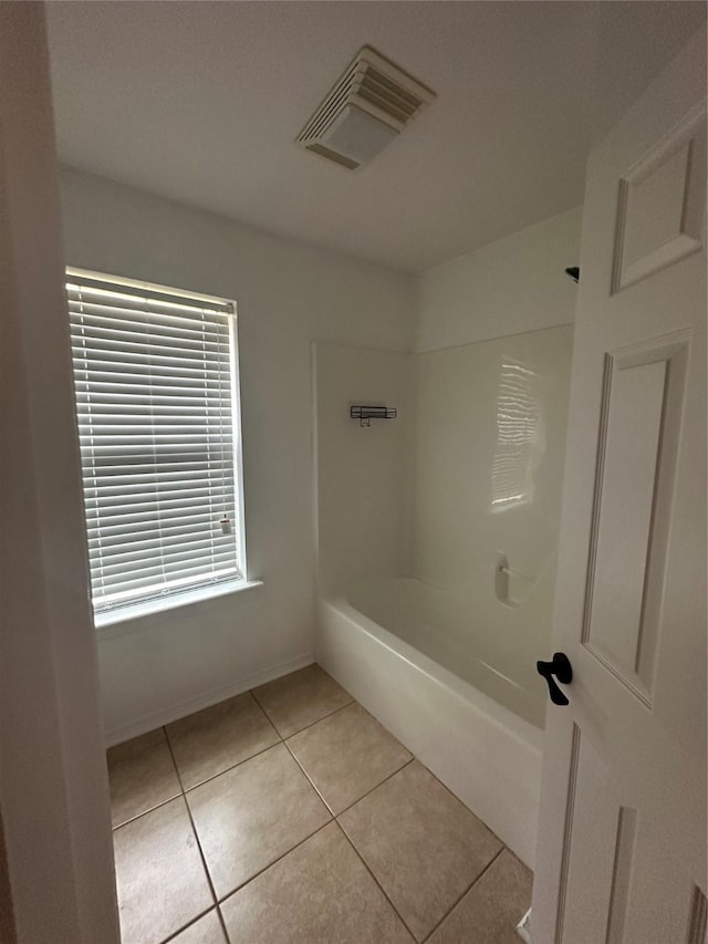 bathroom featuring tile patterned floors, shower / bathing tub combination, baseboards, and visible vents