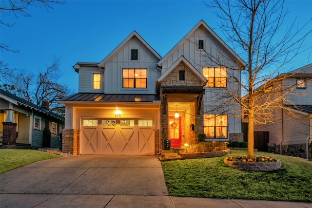 view of front of property featuring an attached garage, concrete driveway, board and batten siding, a standing seam roof, and a front yard