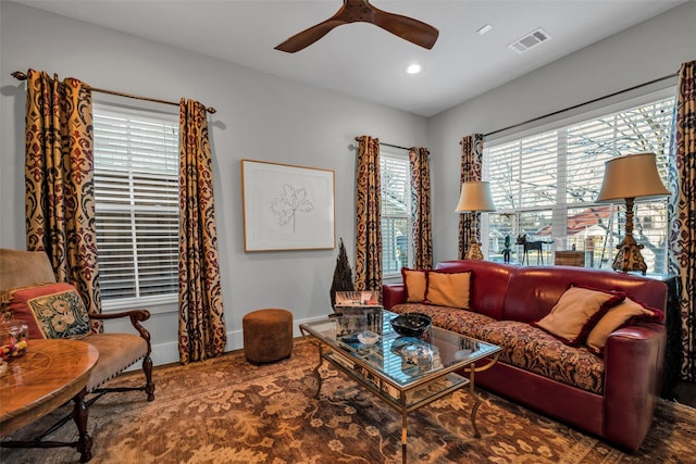 living room with ceiling fan, recessed lighting, visible vents, and baseboards