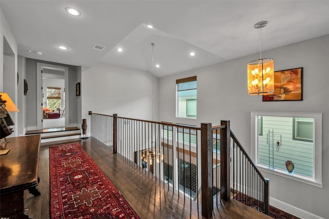 corridor with baseboards, visible vents, wood finished floors, and recessed lighting