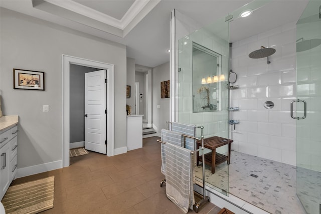 bathroom with a stall shower, baseboards, tile patterned flooring, crown molding, and vanity