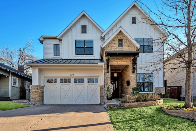 view of front facade with an attached garage, driveway, stone siding, board and batten siding, and a standing seam roof