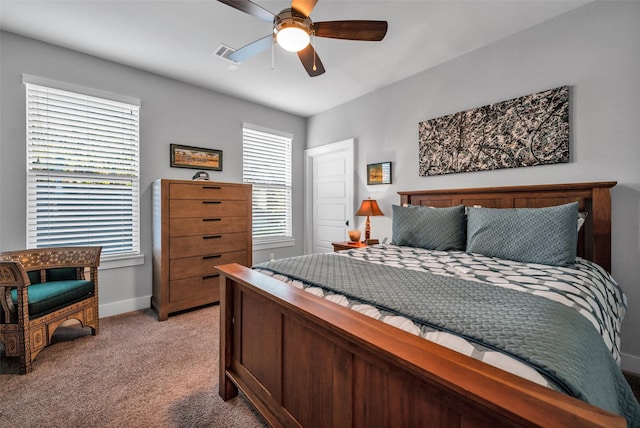 bedroom featuring light carpet, ceiling fan, visible vents, and baseboards