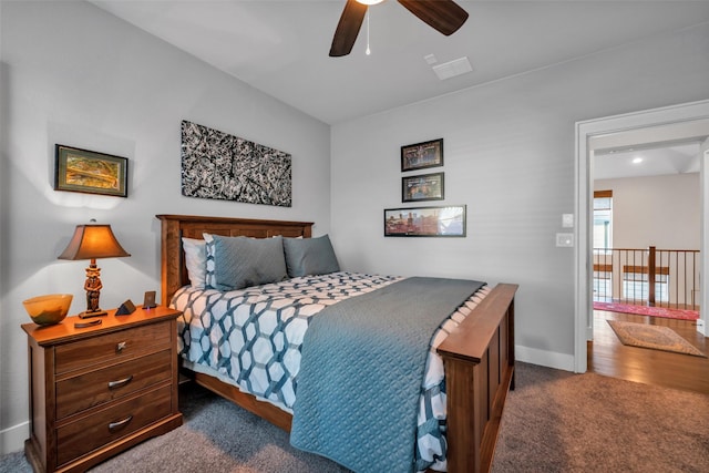 bedroom featuring dark carpet, baseboards, and ceiling fan