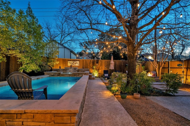 view of pool featuring a fenced in pool, a fenced backyard, a patio, and a fire pit