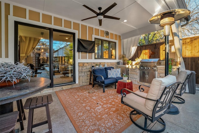 view of patio / terrace with an outdoor kitchen, a ceiling fan, grilling area, fence, and an outdoor living space