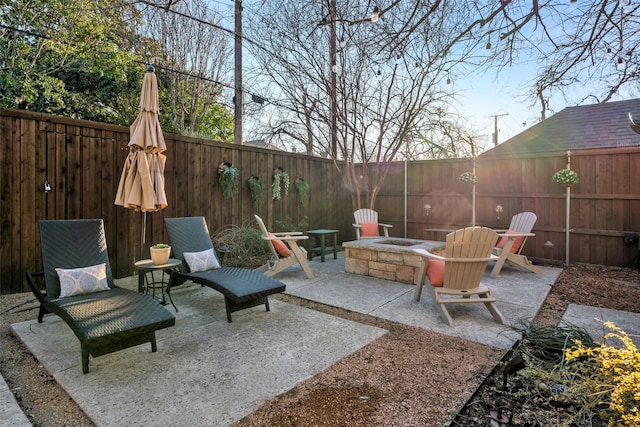 view of patio / terrace with an outdoor fire pit and a fenced backyard