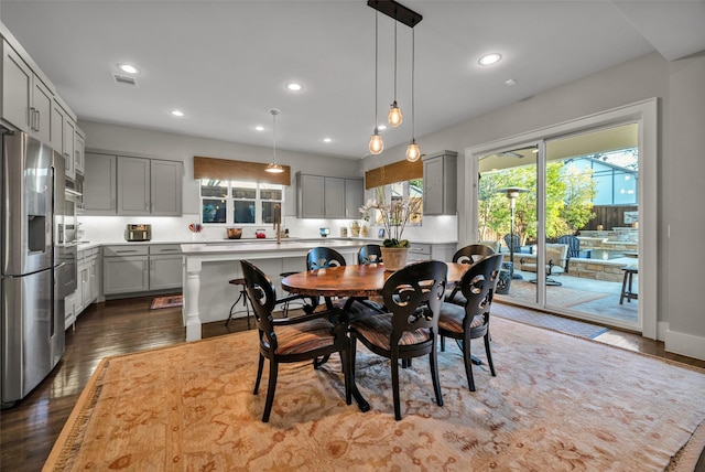 dining room with dark wood-style floors, recessed lighting, and visible vents