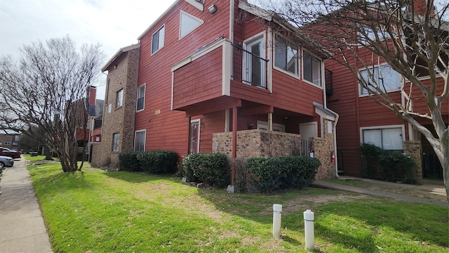 view of side of home with a lawn