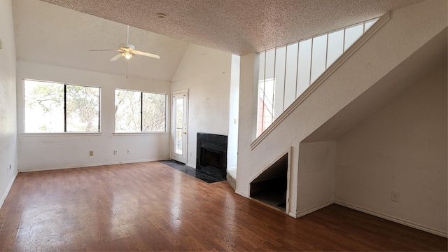 unfurnished living room featuring a fireplace with flush hearth, a ceiling fan, a textured ceiling, and wood finished floors