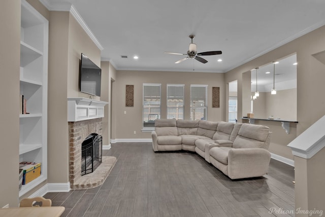 living room with ceiling fan, dark wood-style flooring, a fireplace, baseboards, and crown molding