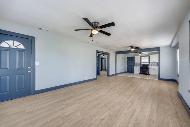 unfurnished living room featuring light wood-type flooring, visible vents, and baseboards