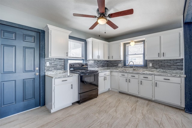 kitchen featuring white cabinetry, decorative backsplash, a wealth of natural light, and black electric range oven