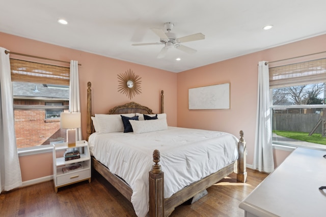 bedroom featuring recessed lighting, multiple windows, baseboards, and wood finished floors