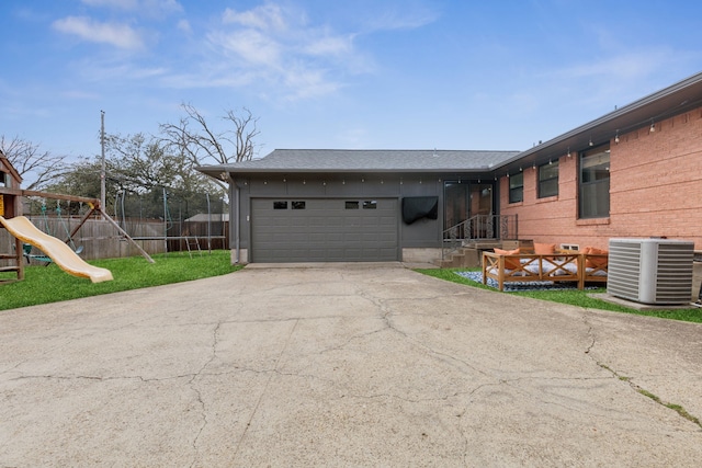 view of front of property featuring a playground, cooling unit, a garage, fence, and driveway