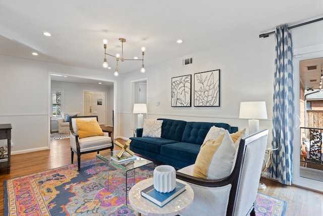 living area featuring visible vents, wood finished floors, and recessed lighting