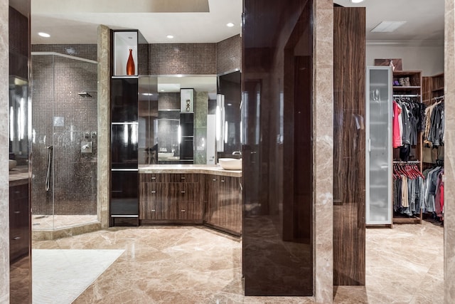 17704 Cedar Creek Canyon Dr, Dallas, TX 75252 - bathroom with a shower stall, a spacious closet, marble finish floor, vanity, and crown molding
