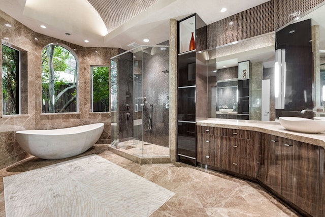 17704 Cedar Creek Canyon Dr, Dallas, TX 75252 - bathroom featuring marble finish floor, a freestanding bath, tile walls, and a stall shower