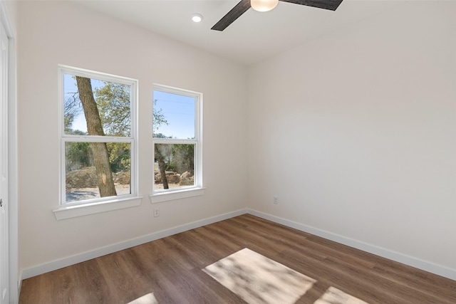 unfurnished room with baseboards and wood finished floors