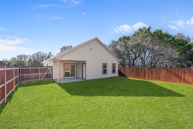 back of house featuring a lawn, a patio area, and a fenced backyard