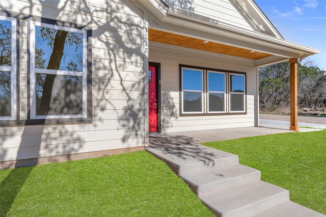 doorway to property featuring a lawn