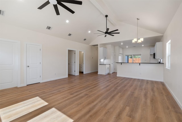 unfurnished living room featuring light wood-type flooring, baseboards, visible vents, and beam ceiling