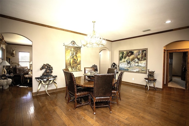 dining area with an inviting chandelier, visible vents, arched walkways, and dark wood finished floors