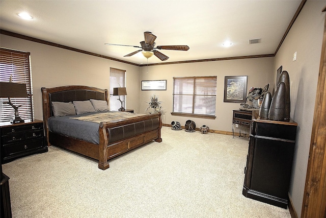 carpeted bedroom with ceiling fan, ornamental molding, visible vents, and baseboards