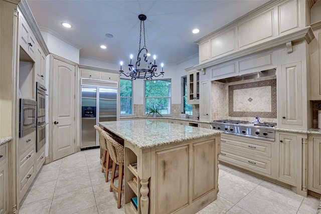 kitchen featuring a center island, built in appliances, crown molding, a chandelier, and open shelves